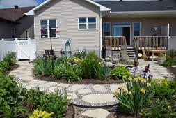 Circular flagstone garden behind a house